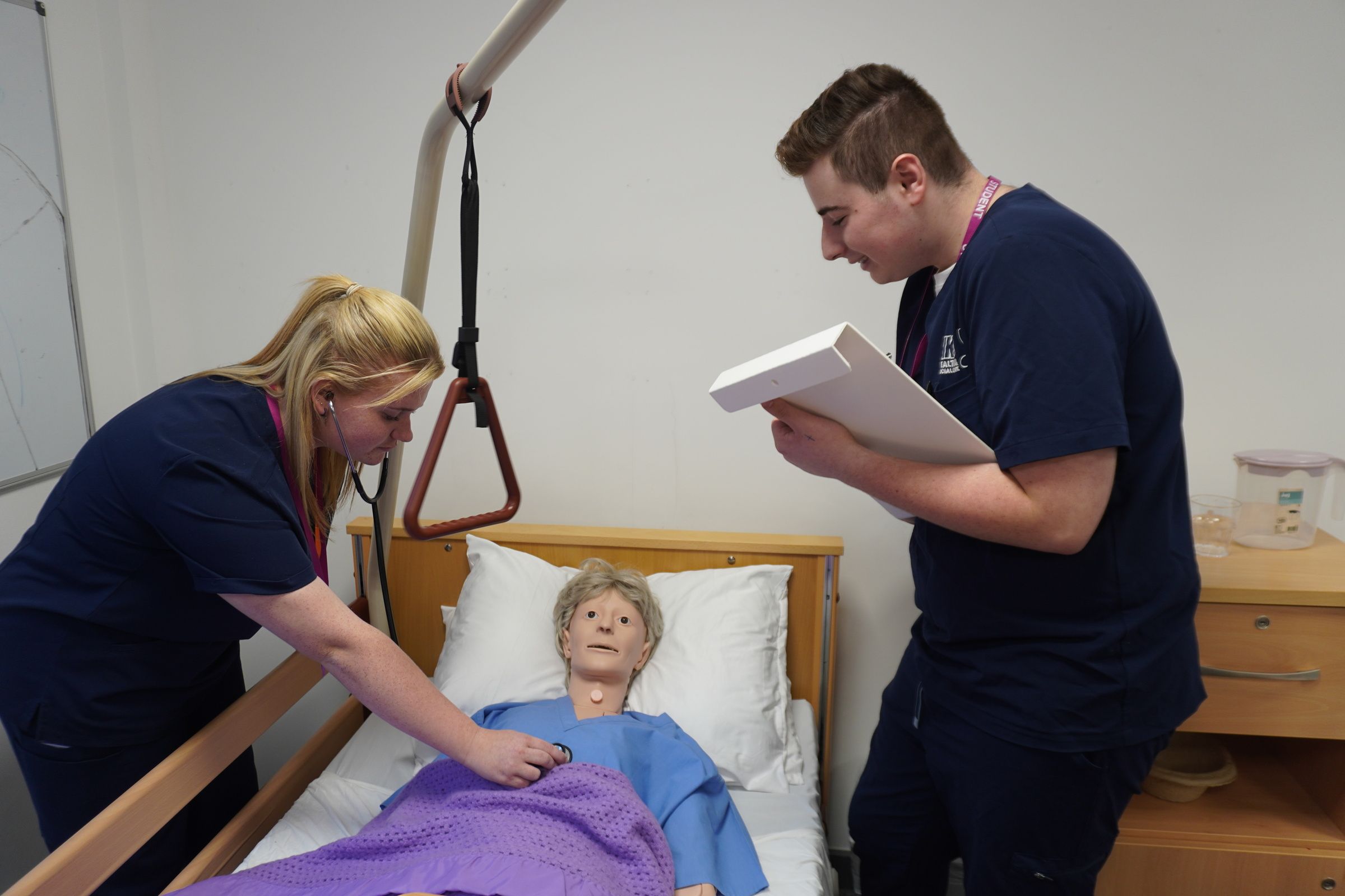 Students looking after patient