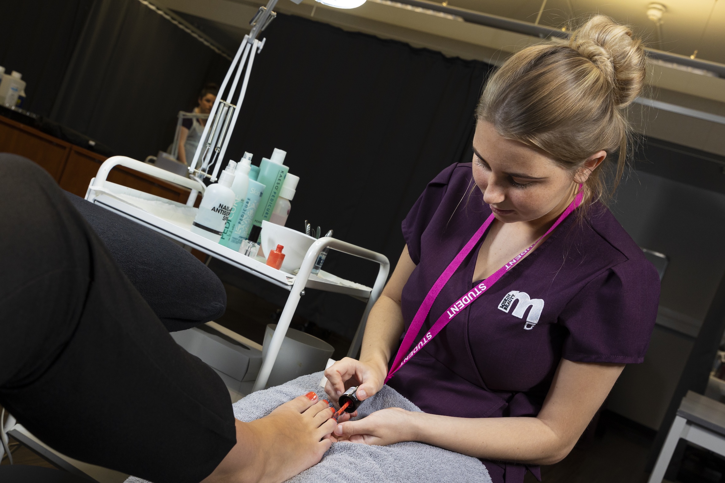 Beauty student painting toe nails