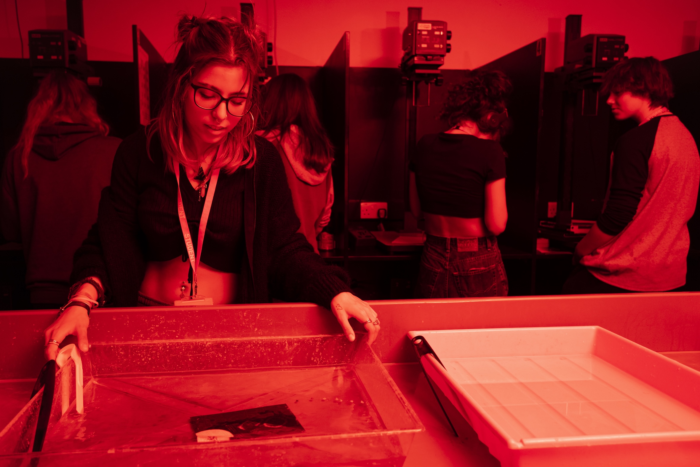 Student in photography dark room