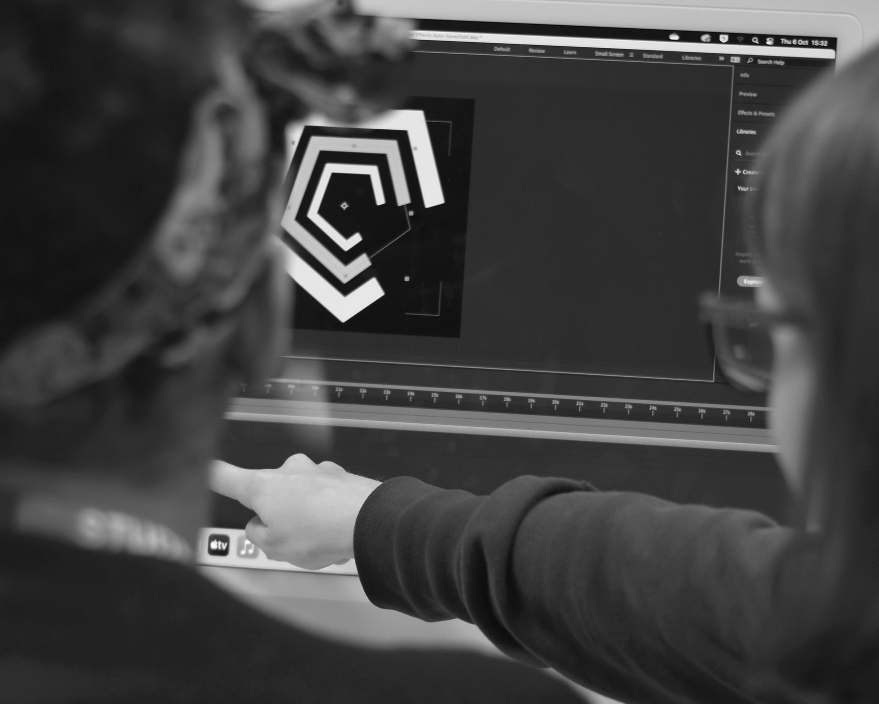 student pointing at computer screen