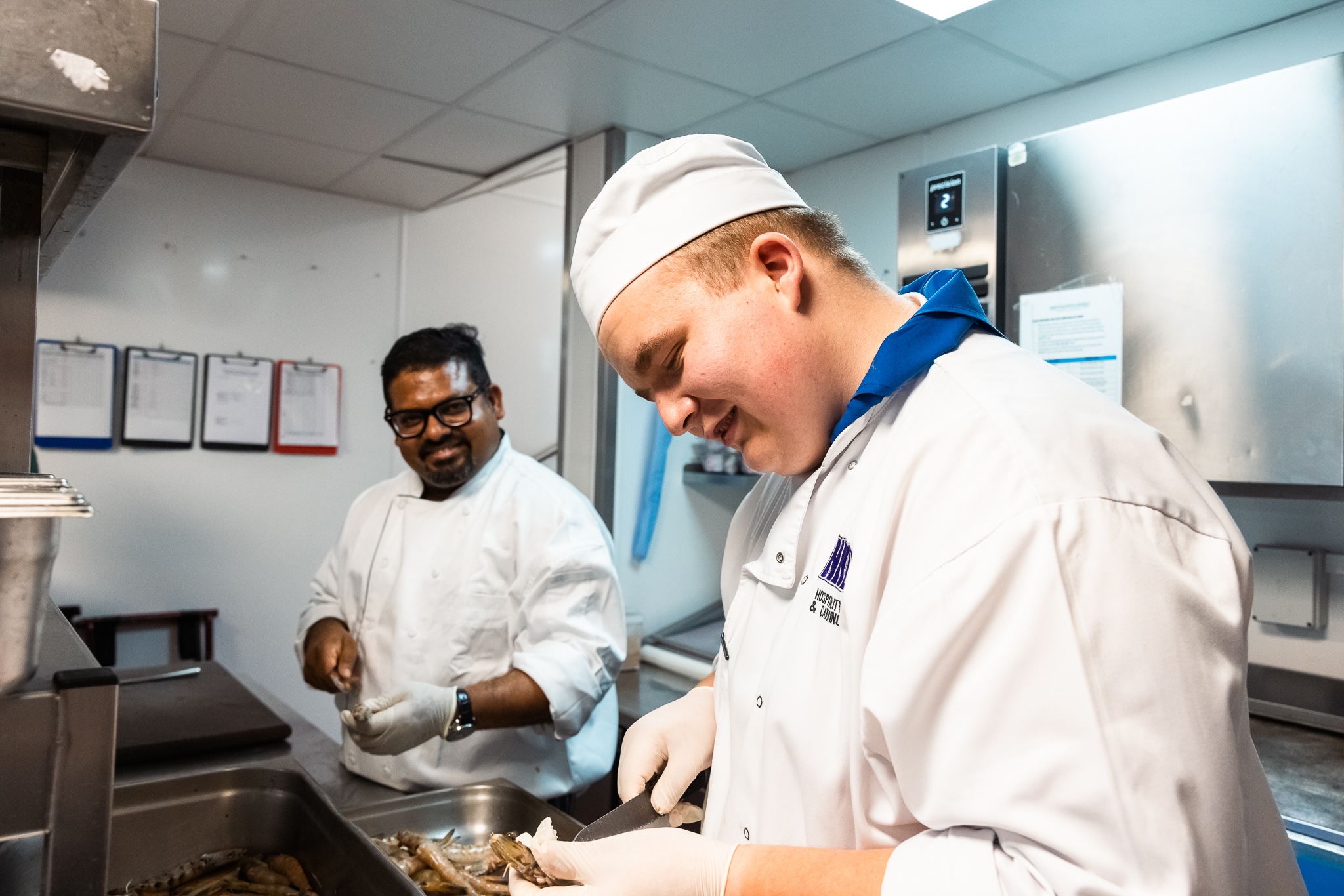 Two chefs in the kitchen preparing food